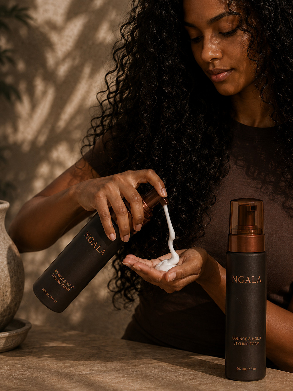 A woman dispensing Bounce & Hold Styling Foam into her hand